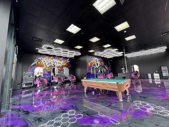 Team Perfect shop interior with barber stations and pool table